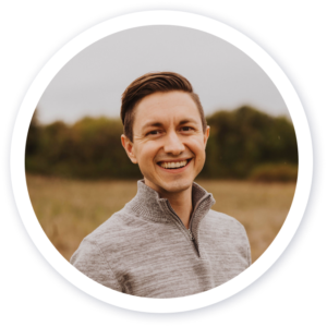 Smiling man in gray sweater inside circular frame